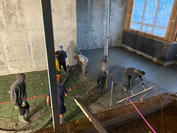 Crew pouring a residential basement floor